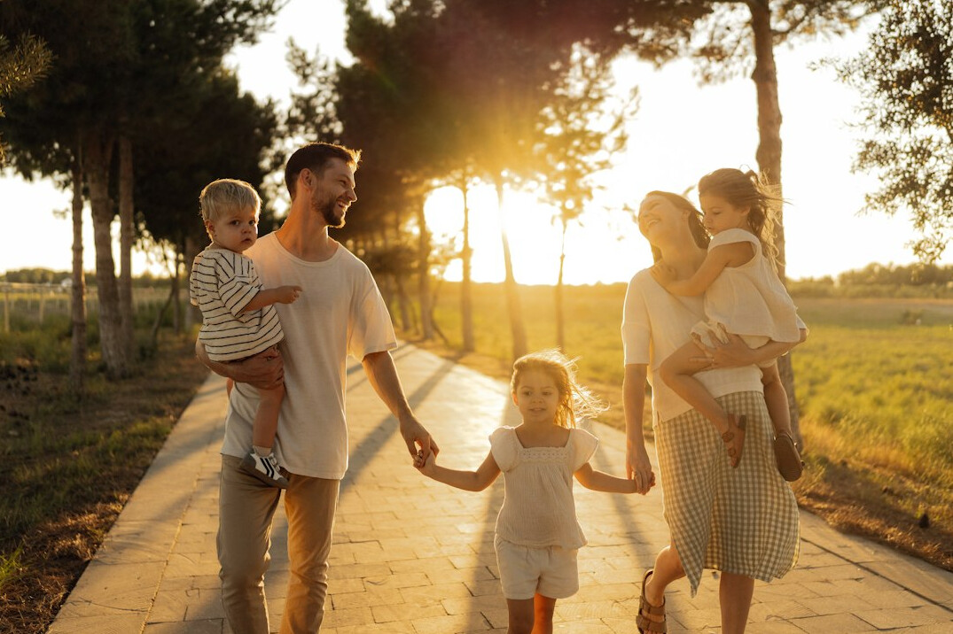 Young Singaporean family sitting together at home smiling