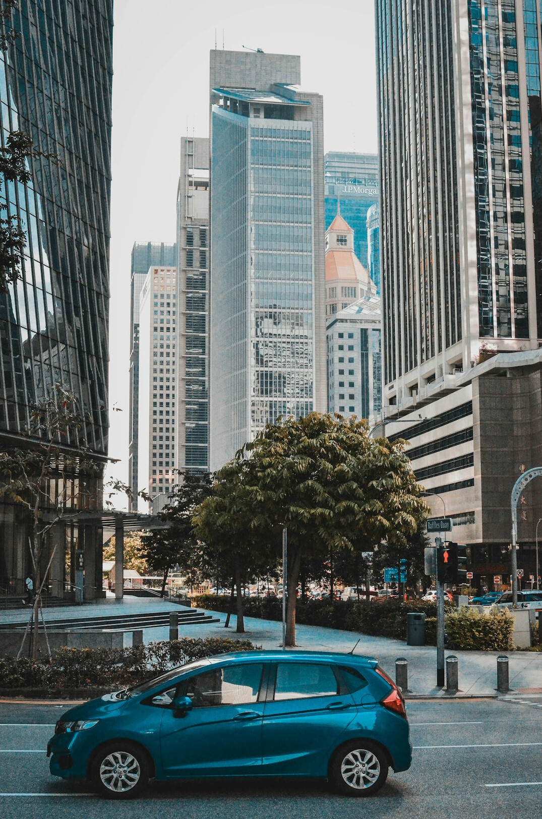Modern car parked on a Singapore street with buildings in the background
