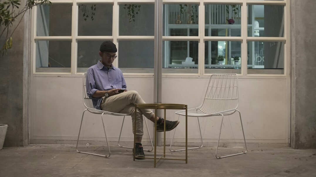 Insurance software consultant working on a laptop showing a policy dashboard